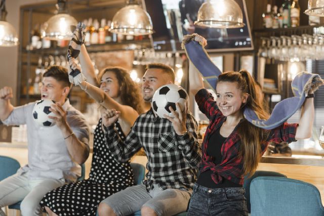 images/soccer-fans-sitting-bar-celebrating-victory.jpg