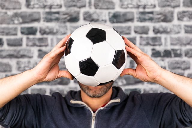 images/close-up-man-holding-soccer-ball-against-wall.jpg