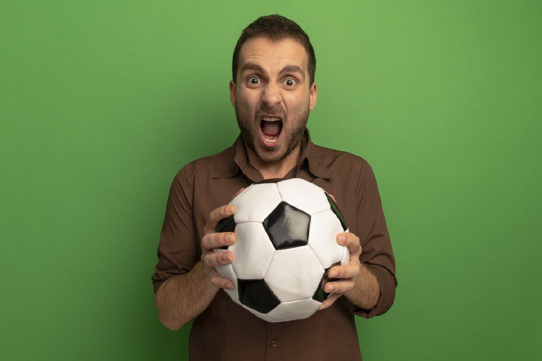 images/furious-young-man-holding-soccer-ball-looking-front-screaming-isolated-green-wall.jpg